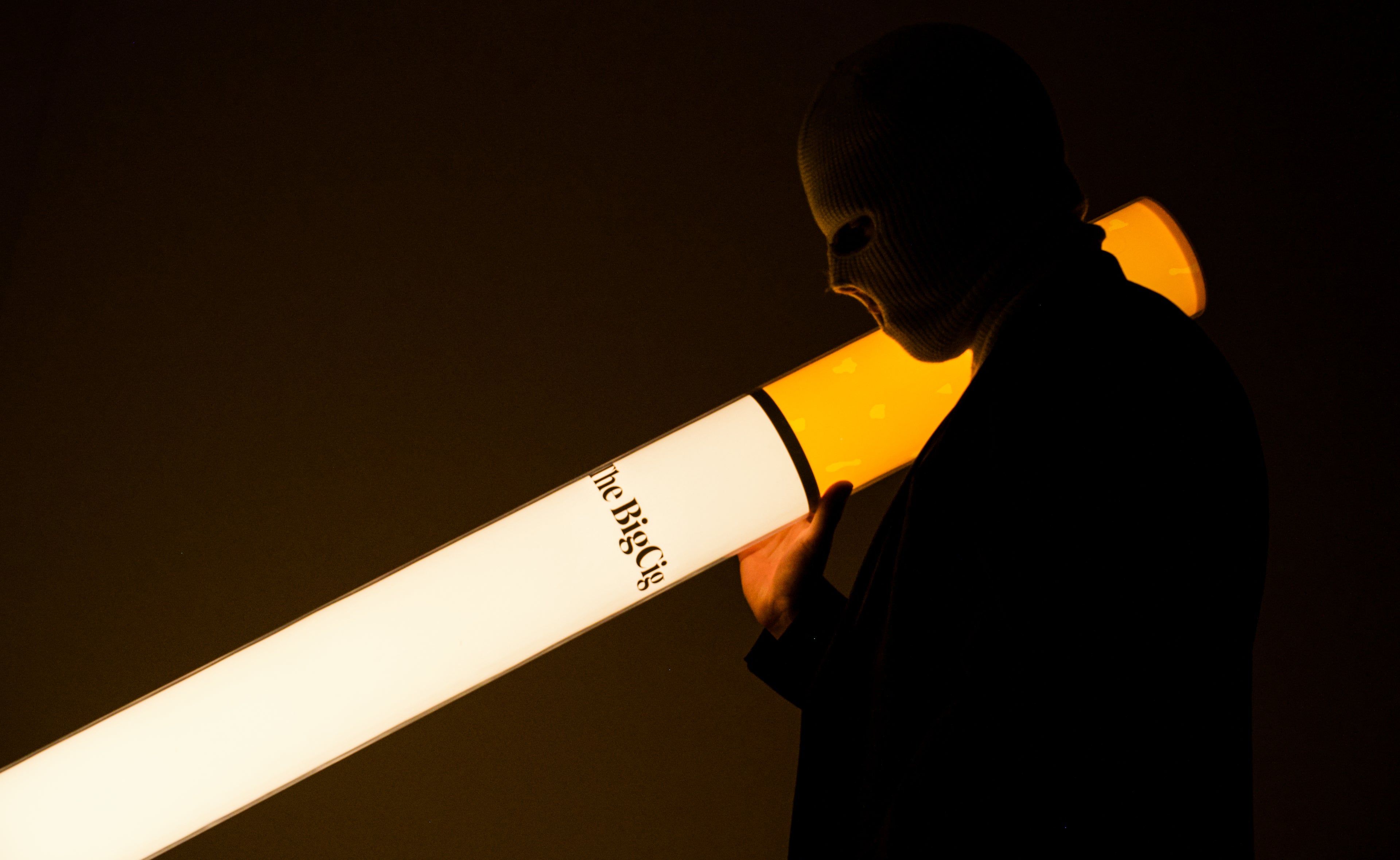 Person holding The BigCig against a dark background